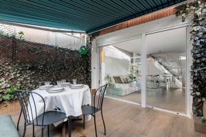 una sala da pranzo con tavolo e sedie di Chalet independiente de diseño con Patio Privado a Madrid