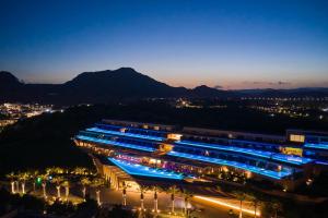 a group of buildings lit up at night at Atlantica Imperial Resort - Adults Only in Kolymbia