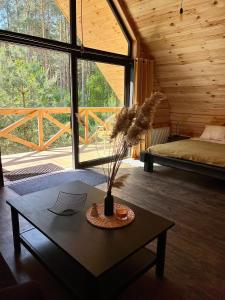 a room with a coffee table and a bed and a large window at Labieši in Jūrmala