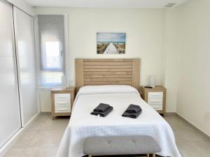 a bedroom with a bed with two towels on it at OCEAN HOMES, Luxury Apartments - By AC REAL in Isla Canela