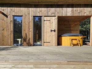 a wooden building with a picnic table on a deck at PolanaKubicy,pl in Nowe Miasto