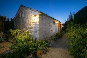 a brick building with lights on the side of it at Stone House Harmony in Korčula