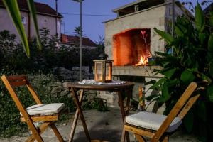 a table with two chairs and a fire place at Stone House Harmony in Korčula