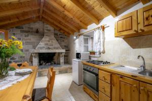 a kitchen with a stove and a stone fireplace at Stone House Harmony in Korčula