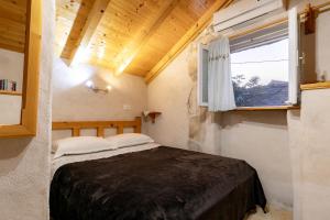 a bedroom with a bed in a room with a window at Stone House Harmony in Korčula