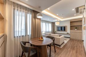 a living room with a table and chairs and a couch at Garden View Court Suites Ho Chi Minh City in Ho Chi Minh City