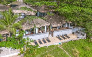 an aerial view of a house with chairs and a beach at Sealord Naithon Beachfront Villa in Nai Thon Beach