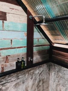 a room with two bottles on a wooden wall at Coco Camping Koh Kood in Ban Khlong Chao