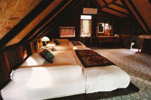 a bedroom with two beds in a attic at Coco Camping Koh Kood in Ban Khlong Chao