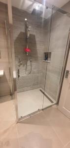 a shower with a red umbrella in a bathroom at Ballymena/ Belfast/ Antrim Coast/Galgorm in Ballymena +45 photos