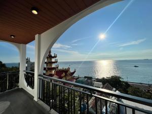 a balcony with a view of the ocean at KIM Apartments in Vung Tau