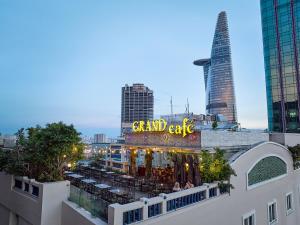 a view of a grand café with a view of the city at Hotel Grand Saigon in Ho Chi Minh City