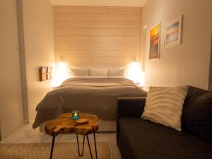 a bedroom with a bed and a couch and a table at Ylläs Kanerva 108 in Ylläs