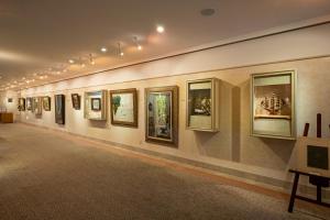 a gallery with framed photographs on a wall at Awashima Hotel in Numazu