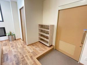 a room with a closet and a door with shelves at Sabae Daiichi Hotel in Sabae