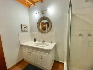 a bathroom with a sink and a mirror at Critchely Stone Villa, Dullstroom in Dullstroom