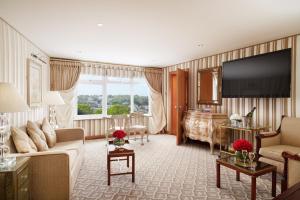 a living room with a couch and a television at Duke Of Richmond Hotel in St. Peter Port