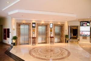 a lobby with a large rug on the floor at Hotel Grand Saigon in Ho Chi Minh City