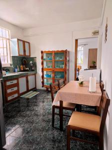 a kitchen and dining room with a table and chairs at Port Louis Centre penthouse in Port Louis