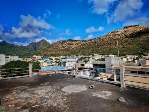 a view of a city with mountains in the background at Port Louis Centre penthouse in Port Louis