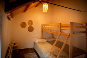 a bedroom with two bunk beds and a ladder at Refugio de los Sueños in Valdeganga