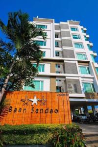 a large apartment building with a sign in front of it at Baan Sandao Unit 303 in Hua Hin