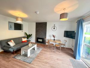 a living room with a couch and a table at Seascape Bliss - Coastal Retreat in Youghal`s heart - Family Friendly - Long Term Price Cuts in Youghal