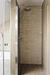 a shower with a glass door in a bathroom at Boutique apartmán in Krompachy