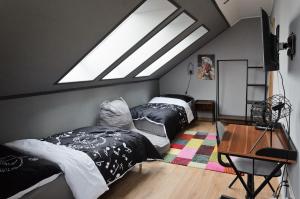 a attic bedroom with two beds and a skylight at Boutique apartmán in Krompachy