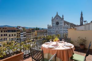 a table on a balcony with a view of a church at Palazzo Antellesi in Florence