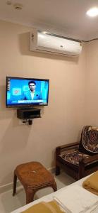 a living room with a flat screen tv on the wall at OYO Hotel Swagat Inn in Cuttack