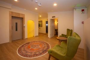 a living room with a couch and chairs and a rug at Porta Romanos Hotel in Istanbul