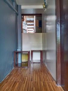 an empty room with wood floors and a staircase at Z&J Transient Pad in Butuan