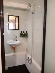 a bathroom with a sink and a shower at Z&J Transient Pad in Butuan