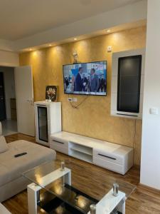 a living room with a flat screen tv on the wall at Stan na dan Bratunac in Bratunac