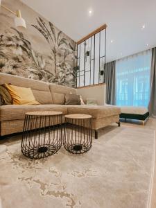 a living room with a couch and two tables at Paulay 11 Center Designer Apartment in Budapest