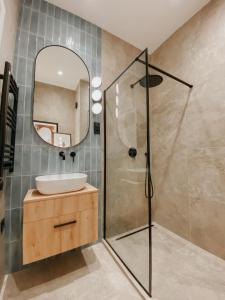 a bathroom with a shower and a sink and a mirror at Paulay 11 Center Cosy Apartment in Budapest