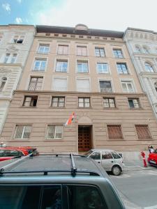 a building with a car parked in front of it at Paulay 11 Center Cosy Apartment in Budapest