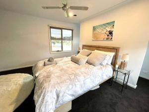 a bedroom with a large bed and a window at Great Ocean Views Torquay in Torquay