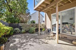 a patio with a table and a chair in front of a house at Great Ocean Views Torquay in Torquay