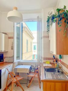 a kitchen with a sink and a window at Domus Lido in Lido di Ostia