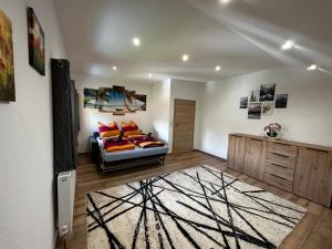 a living room with a couch and a rug at Ferienwohnung Rief in Tannheim