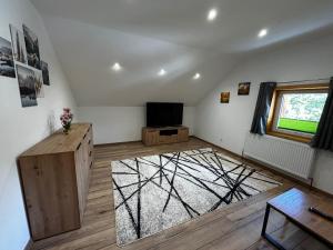a living room with a television and a table at Ferienwohnung Rief in Tannheim