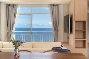 a living room with a view of the ocean at Chic Design & Full Seaview 2BR Karon Condo 16C, near Beach in Karon Beach
