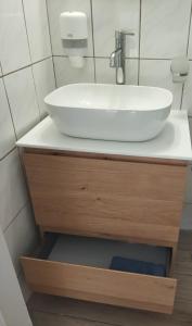a bathroom with a white sink on a counter at Spiros Sea View in Nydri