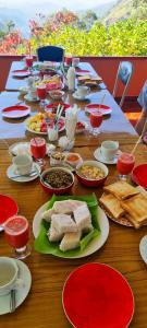 a long table with plates of food on it at Hilltop Guest House in Ella +48 photos
