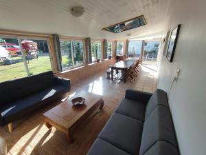 a living room with a couch and a table at Pascanono - Location de maison de vacances avec jardin pour séjour à Le Palais, Belle-Ile-en-mer in Le Palais