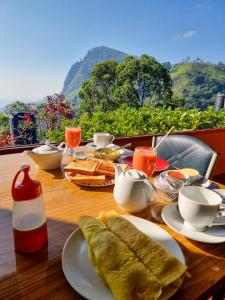 a table with plates of food on top of it at Hilltop Guest House in Ella