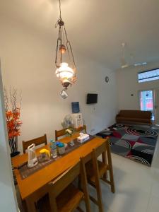 a dining room with a table and a bed at Walasa Homes Werdyningsih 