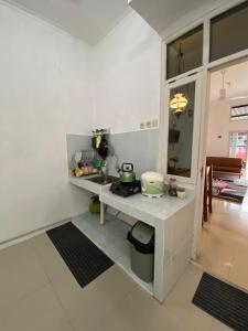 a kitchen with a counter and a sink in a room at Walasa Homes Werdyningsih 